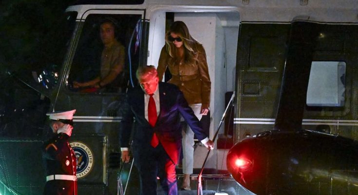 donald Trump and Melania Trump disembark Marine One at night, Marine salutes
